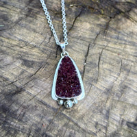 Druzy amethyst pendant set in sterling silver accented at the base with 3 silver spheres.