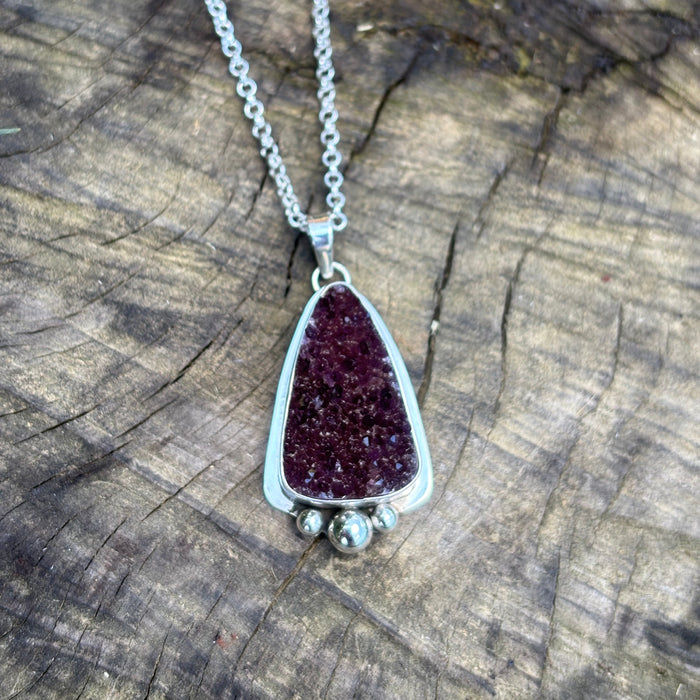 Druzy amethyst pendant set in sterling silver accented at the base with 3 silver spheres.